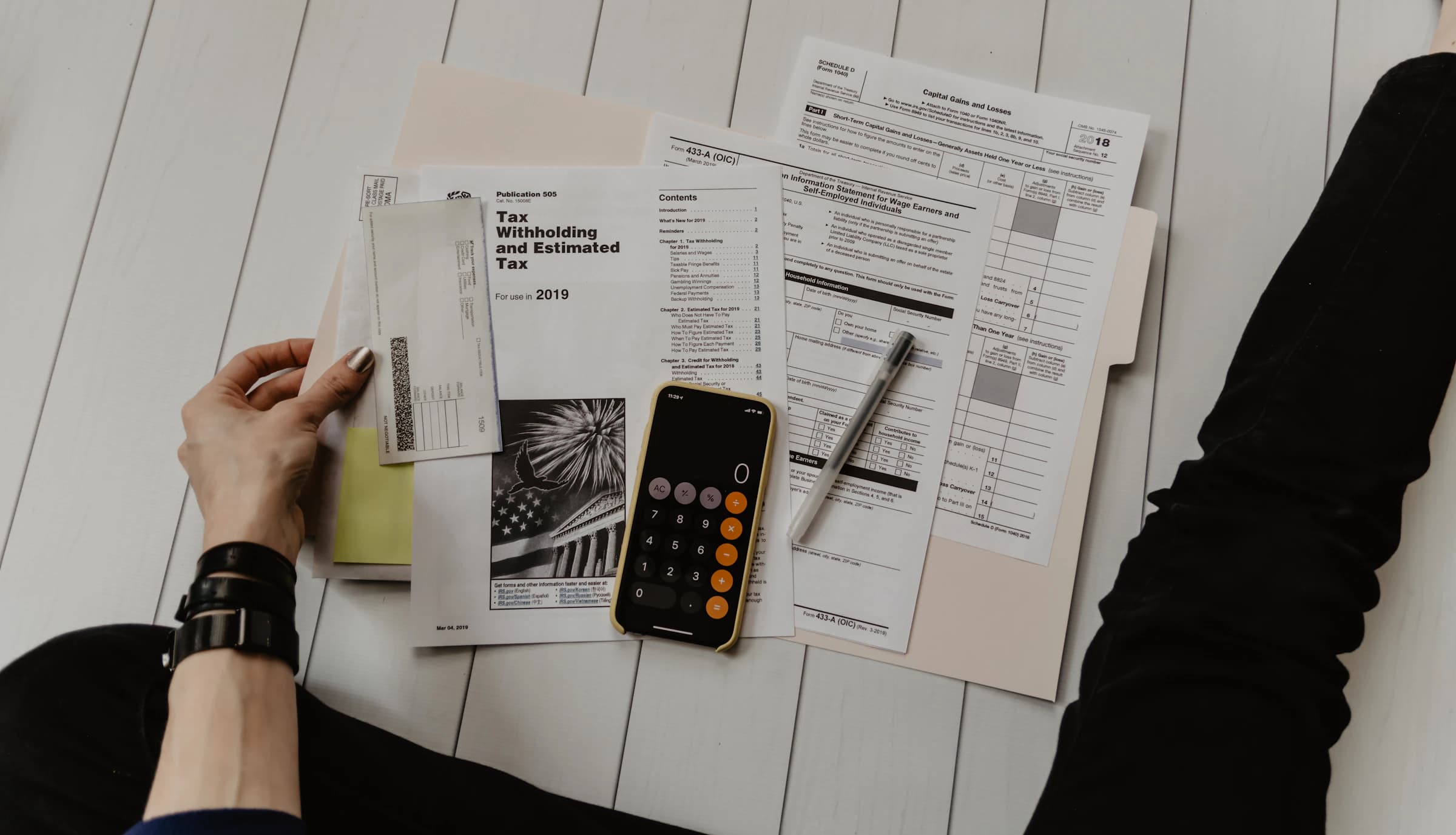 Cross-border tax research — documents and city skyline at dusk