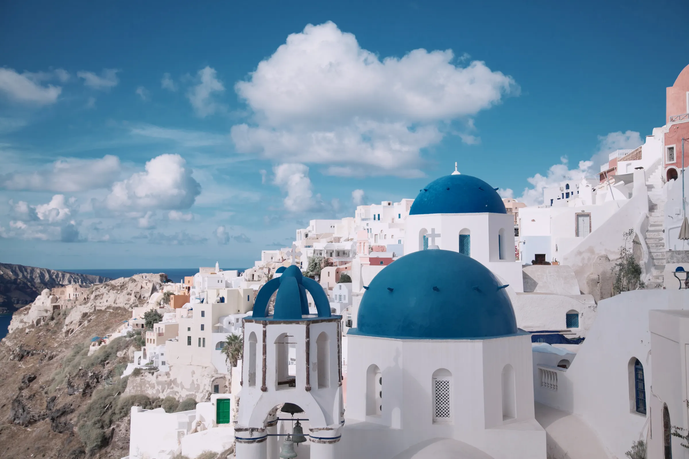 Santorini hillside dwellings — Greece Golden Visa property thresholds